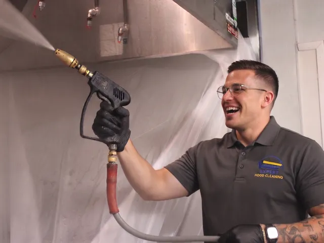 Expert Hood Cleaning technician degreasing a commercial kitchen exhaust hood